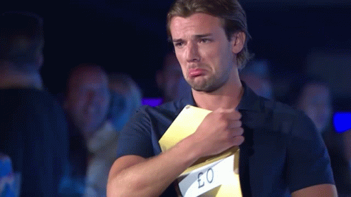 A Man In A Blue Shirt Is Crying While Holding A Card That Says Eo GIF