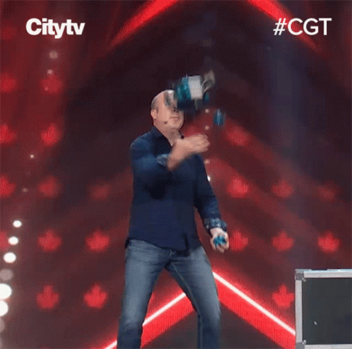 A Man In A Blue Shirt Is Dancing On A Stage In Front Of A Sign That Says City Tv GIF