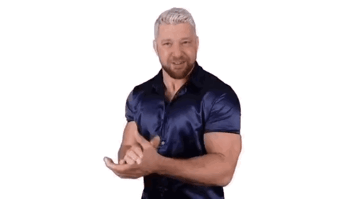 A Man In A Blue Shirt Is Dancing With His Hands Outstretched . GIF