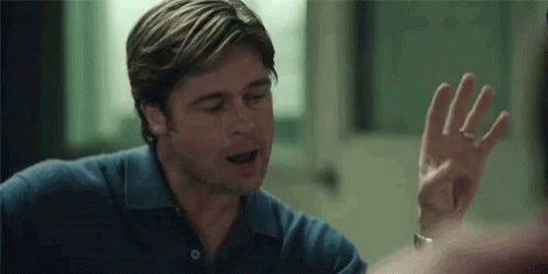 A Man In A Blue Shirt Is Giving A High Five To Someone . GIF
