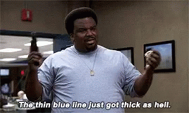 A Man In A Blue Shirt Is Holding A Bottle Of Beer And Says `` The Thin Blue Line Just Got Thick As Hell . '' GIF