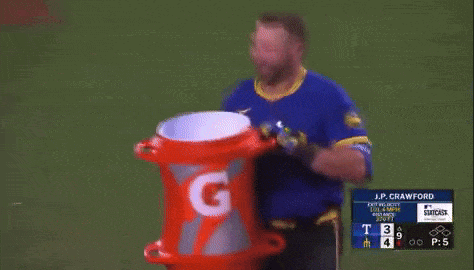A Man In A Blue Shirt Is Holding A Gatorade Can GIF