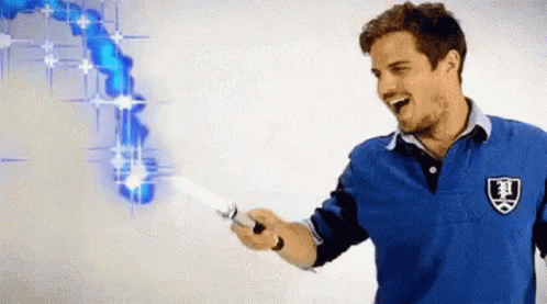 A Man In A Blue Shirt Is Holding A Knife With A Shield On It GIF