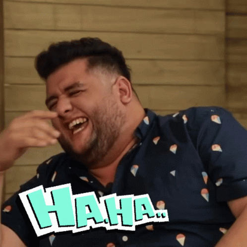 A Man In A Blue Shirt Is Laughing With The Word " Haha " Next To Him GIF