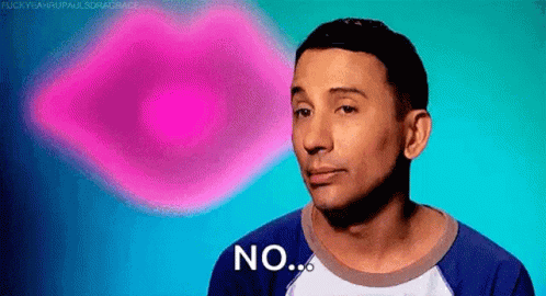 a man in a blue shirt is making a funny face and says no .