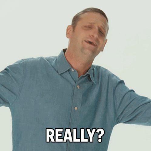 A Man In A Blue Shirt Is Making A Funny Face And Says Really GIF