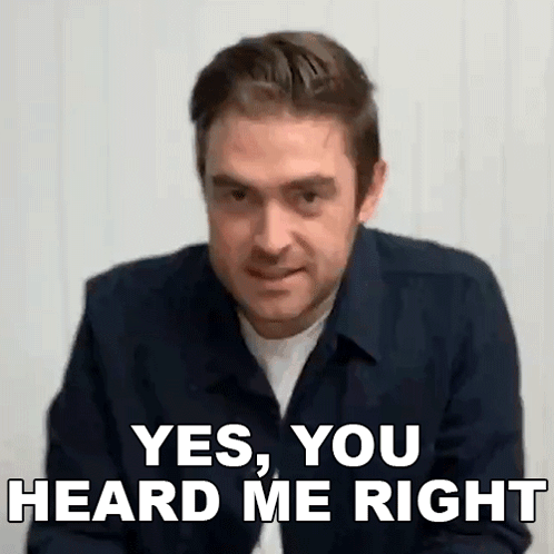 A Man In A Blue Shirt Is Making A Funny Face And Says `` Yes , You Heard Me Right '' . GIF