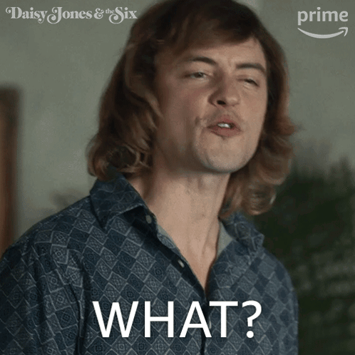 A Man In A Blue Shirt Is Making A Funny Face And The Word What Is On The Front Of His Shirt GIF