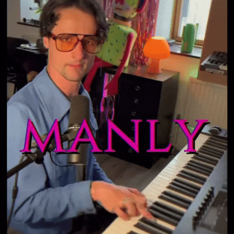A Man In A Blue Shirt Is Playing A Keyboard With The Word Manly In Pink GIF