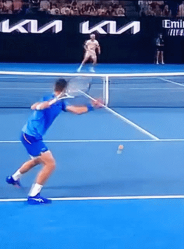 A Man In A Blue Shirt Is Playing Tennis On A Court Sponsored By Kia GIF