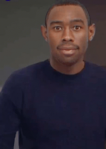 A Man In A Blue Shirt Is Pointing His Finger GIF