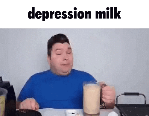 A Man In A Blue Shirt Is Sitting At A Table Drinking A Glass Of Depression Milk . GIF