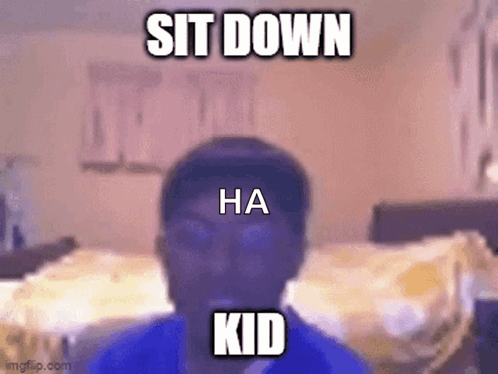A Man In A Blue Shirt Is Sitting Down In A Bedroom . GIF