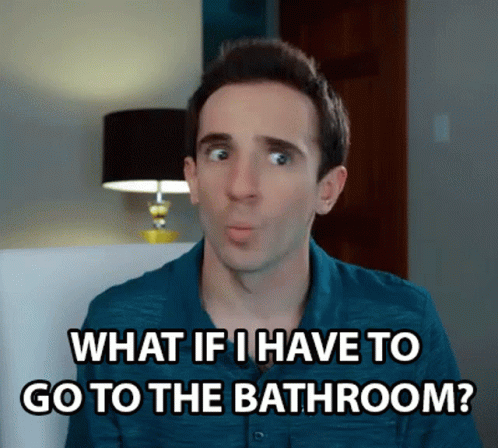 A Man In A Blue Shirt Is Sitting In A Chair And Saying What If I Have To Go To The Bathroom ? GIF