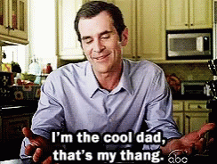 A Man In A Blue Shirt Is Sitting In A Kitchen And Says I 'M The Cool Dad That 'S My Thang GIF