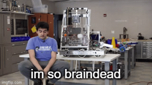 A Man In A Blue Shirt Is Sitting In Front Of A Robot That Says Im So Braindead On It GIF
