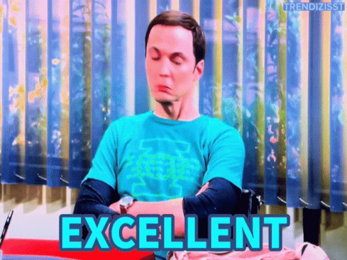 a man in a blue shirt is sitting in front of a window and the word excellent is on the screen behind him