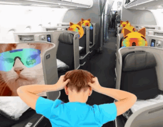A Man In A Blue Shirt Is Sitting On An Airplane GIF
