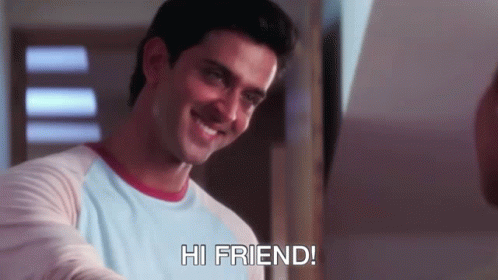 A Man In A Blue Shirt Is Smiling And Says Hi Friend GIF