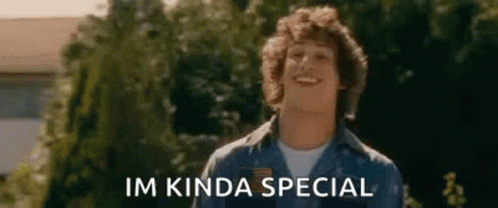 A Man In A Blue Shirt Is Smiling In Front Of Trees And The Words `` Im Kinda Special '' . GIF