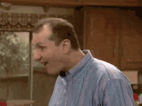Man In Blue Shirt With Mouth Open In Kitchen GIF