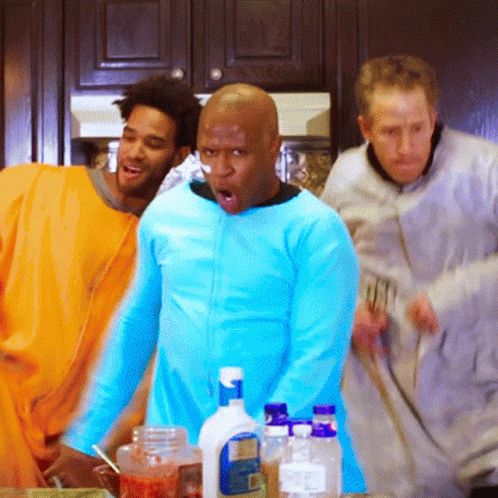 A Man In A Blue Shirt Is Standing In Front Of A Bottle Of Dawn GIF