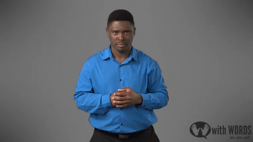A Man In A Blue Shirt Is Standing In Front Of A Sign That Says With Words GIF