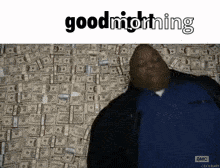 A Man In A Blue Shirt Is Standing In Front Of A Wall Of Money And Says Goodnight GIF