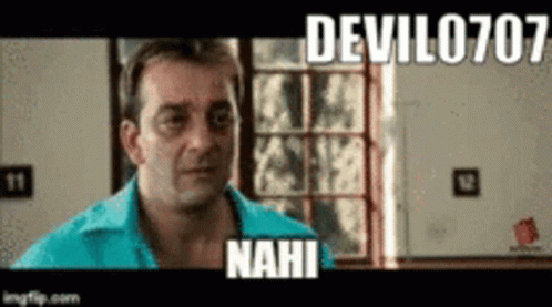 A Man In A Blue Shirt Is Standing In Front Of A Window And A Sign That Says Devil0707 Nahi . GIF