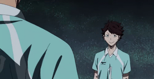 A Man In A Blue Shirt Is Standing Next To Another Man In A Blue Shirt . GIF
