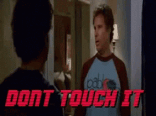 A Man In A Blue Shirt Is Standing Next To Another Man In A Red Shirt . GIF