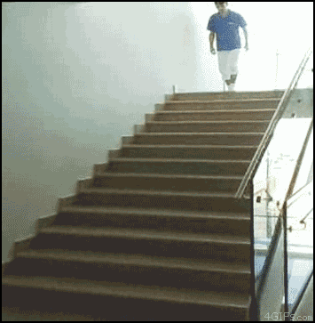 A Man In A Blue Shirt Is Walking Up A Set Of Stairs With 4Gifs.com In The Corner GIF