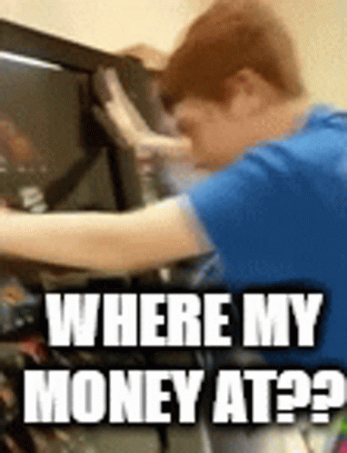A Man In A Blue Shirt Is Working On A Computer And Asking Where His Money Is GIF