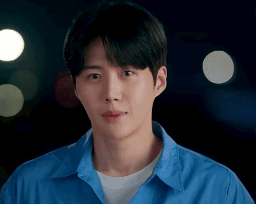 A Man In A Blue Shirt Looks At The Camera GIF