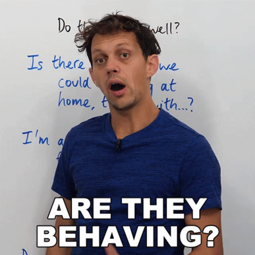 A Man In A Blue Shirt Says Are They Behaving In Front Of A White Board GIF