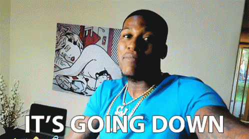 A Man In A Blue Shirt Says It 'S Going Down In Front Of A Painting GIF
