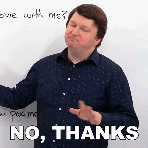 A Man In A Blue Shirt Says No Thanks In Front Of A White Board GIF