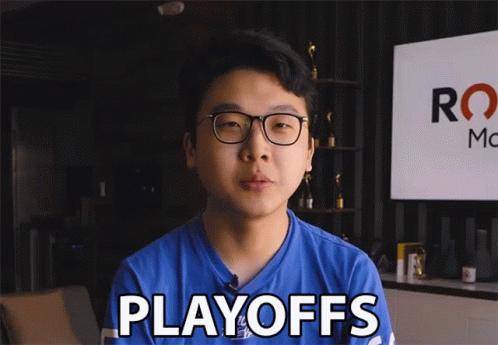 A Man In A Blue Shirt Says Playoffs In Front Of A Sign GIF