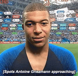 A Man In A Blue Shirt Says Spots Antoine Griezmann Approaching In Front Of A Crowd GIF