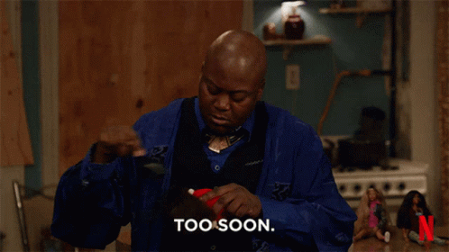 a man in a blue shirt says too soon in front of a netflix logo