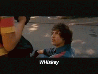 a man in a blue shirt says whiskey in a movie scene