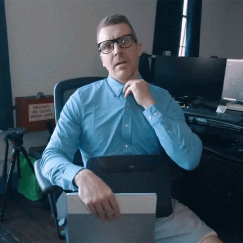 A Man In A Blue Shirt Sits In Front Of An Emergency Window Ladder GIF