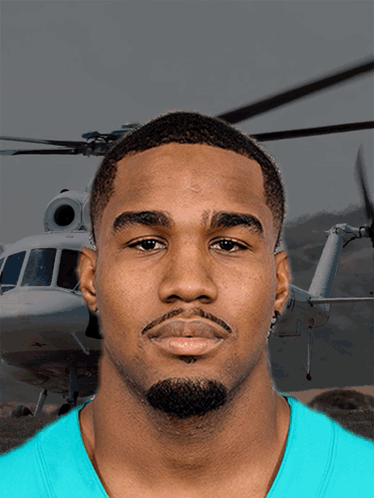 A Man In A Blue Shirt Stands In Front Of A Helicopter That Says ' A ' On It GIF