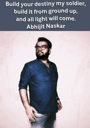 A Man In A Blue Shirt Stands In Front Of A Quote From Abhijit Naskar GIF