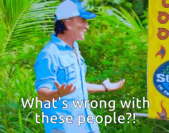 a man in a blue shirt stands in front of a sign that says what 's wrong with these people ?