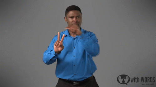 A Man In A Blue Shirt Stands In Front Of A Sign That Says " With Words " GIF