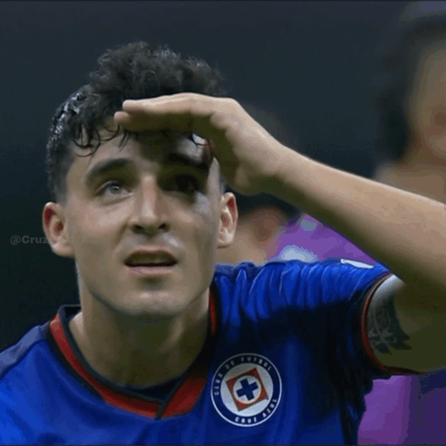 A Man In A Blue Shirt With A Cross On It GIF