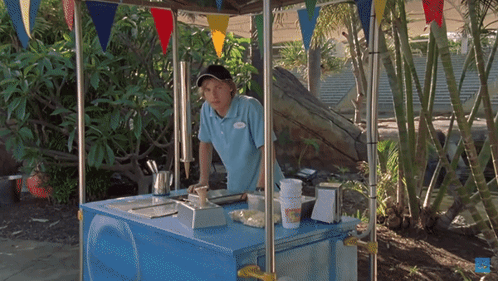 A Man In A Blue Shirt With A Name Tag That Says ' Chris ' GIF
