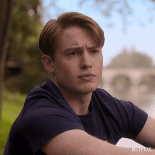 A Man In A Blue Shirt With A Netflix Logo On The Bottom GIF