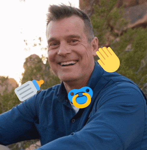 a man in a blue shirt with a pacifier and a bottle on his neck